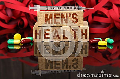 On the surface are visible tablets a syringe wooden dies and their reflections on which it is written - MENS HEALTH Stock Photo