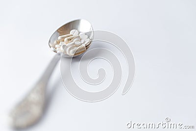 Medicine and health, treatment, pharmacy, coronavirus, pandemic, epidemic concept - layout one silver big tablespoon Stock Photo