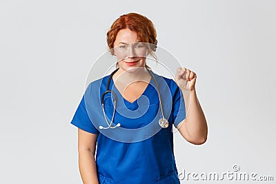 Medicine, healthcare and coronavirus concept. Hopeful and optimistic medical worker showing stay united gesture, clench Stock Photo
