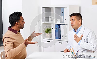 Doctor and displeased male patient argue at clinic Stock Photo