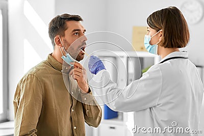 doctor checking male patient& x27;s throat at hospital Stock Photo