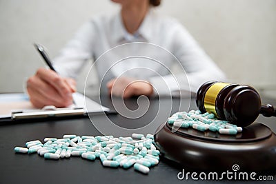 Medicine law concept. Judges gavel with pills Stock Photo