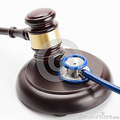 Medicine and medical symbols - close up shot of a wooden judge gavel and a stethoscope Stock Photo