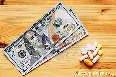 Medicine and money on wooden background. Medicine pills or capsules with money, dollar. Medical or pharmacy prescription for Editorial Stock Photo