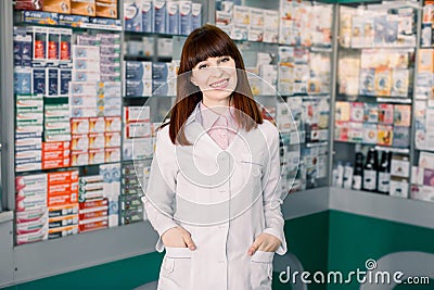 Medicine, pharmaceutics, healthcare and people concept. Portrait of a happy female pharmacist. Cheerful pharmacist Stock Photo