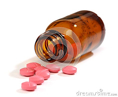 Medicine pills spilling from a bottle Stock Photo