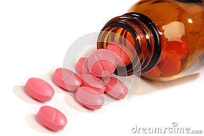 Medicine pills spilling from a bottle Stock Photo