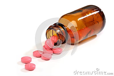 Medicine pills spilling from a bottle Stock Photo