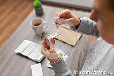 woman making self testing coronavirus test at home Stock Photo