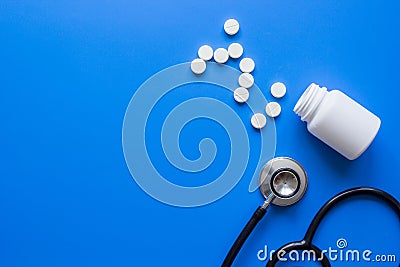 Medicine set with stethoscope and meds on doctor`s workplace blue background top view mockup Stock Photo