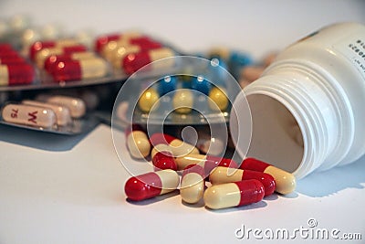Medicine several pills red yellow blue capsules Editorial Stock Photo