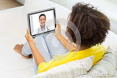 Patient having video chat with doctor on tablet pc Stock Photo