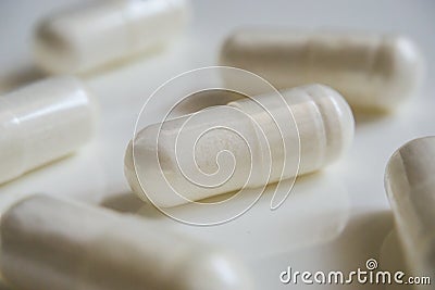 Medicine white pills or capsules on white background with copy space. Pharmaceutical medicament for health. Stock Photo