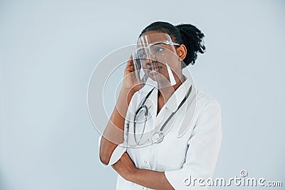 Medicine worker. Young african american woman is against white background Stock Photo