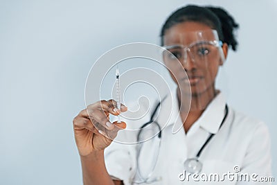 Medicine worker. Young african american woman is against white background Stock Photo