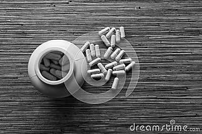 Medicines capsule scattered with white bottle Stock Photo