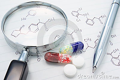 Medicines, magnifier and structure formula. Stock Photo