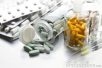 Medicines in tablets, capsules and injections on a metal table Stock Photo