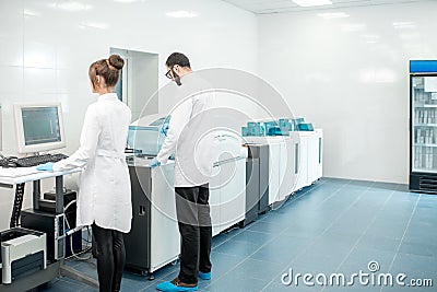 Medics configuring analyzer machine Stock Photo