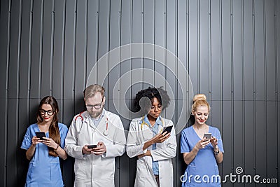 Medics with phones indoors Stock Photo