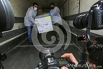 Medics and police officers check a shipment of the Russia`s Sputnik V vaccine for COVID-19 coronavirus disease Editorial Stock Photo
