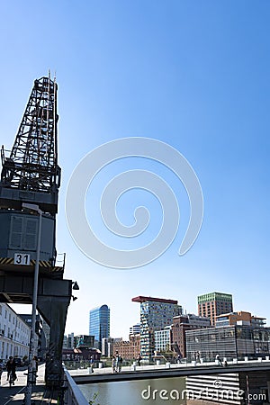 Media Harbour Dusseldorf, New Media Harbor, Medienhafen with old crane and bridge Editorial Stock Photo