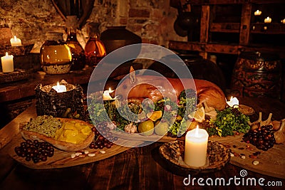Medieval ancient kitchen table with typical food in royal castle. Stock Photo