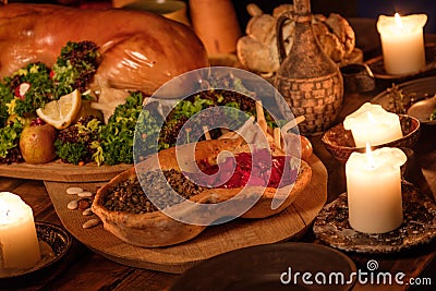 Medieval ancient kitchen table with typical food in royal castle. Stock Photo