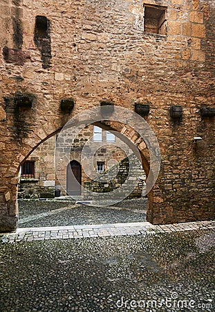 Medieval arched entrance in a stone wall Stock Photo