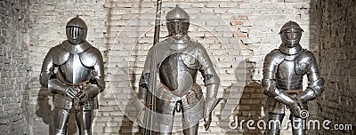 Medieval armor knight steel metal horizontal brick wall brown Stock Photo