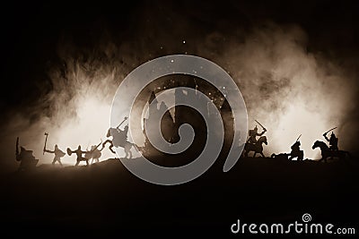 Medieval battle scene with cavalry and infantry. Silhouettes of figures as separate objects, fight between warriors on dark toned Stock Photo