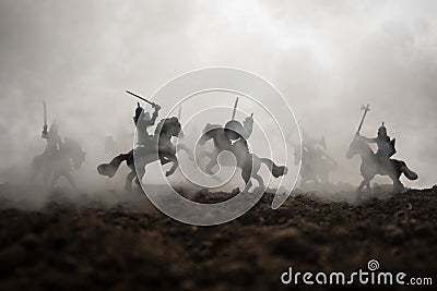 Medieval battle scene with cavalry and infantry. Silhouettes of figures as separate objects, fight between warriors on sunset Stock Photo