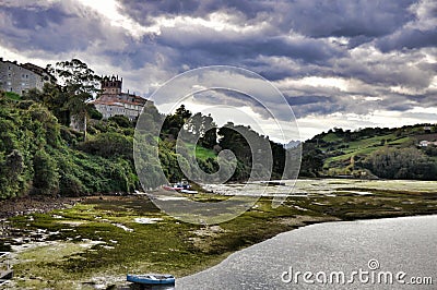 Medieval castle tower and Church of San Vicente de la Barquera Stock Photo