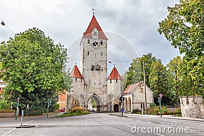Medieval city gate with clock tower in Regensburg Stock Photo