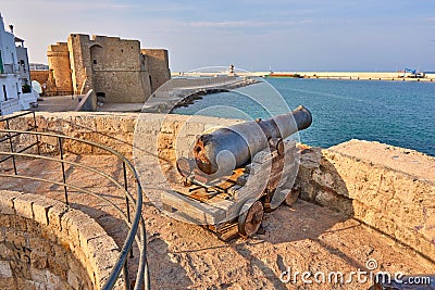 Medieval Defense Cannon and Turret In Front Of Castle Carlo V in beautiful Monopoli - Apulia - Puglia - Italy Stock Photo