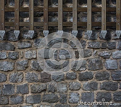 Medieval gate bars on castle stone wall Stock Photo