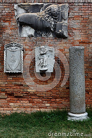 Bas Relief sculptures on brick wall on the island of Torcello, Venice, Italy Editorial Stock Photo