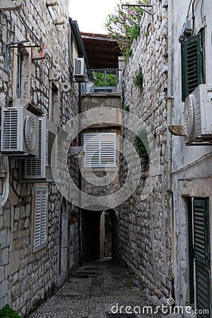 Medieval houses in the narrow streets of Dubrovnik with hanging clothes and stone stairs Stock Photo