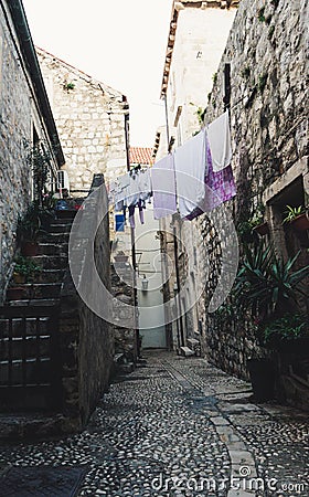 Medieval houses in the narrow streets of Dubrovnik with hanging clothes and stone stairs Stock Photo