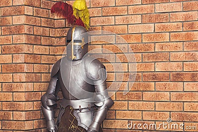 Medieval knight armor against the background of a brick wall Stock Photo