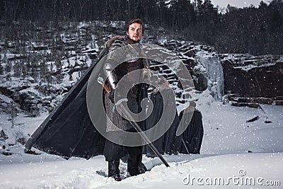 Medieval knight with sword in armor as style Game of Throne Stock Photo