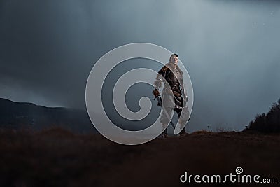 Medieval knight with sword in armor as style Game of Thrones in Stock Photo