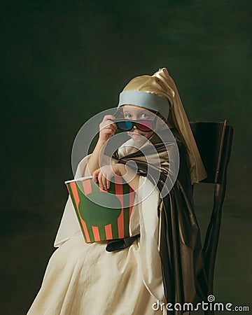 Medieval little girl as a lady with a pearl earring on dark studio background. Concept of comparison of eras, childhood Stock Photo