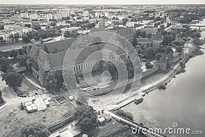 Medieval Malbork Marienburg Castle in Poland, main fortress of the Teutonic Knights at the Nogat river. Aerial view in fall in Stock Photo