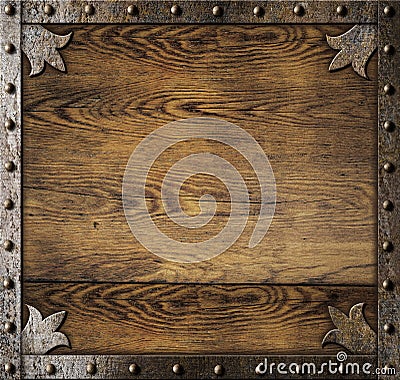 Medieval metal frame over old wooden background Stock Photo