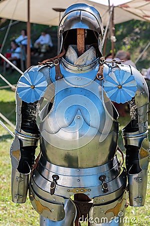 Medieval Metallic Armor with Helmet near White Tent Stock Photo
