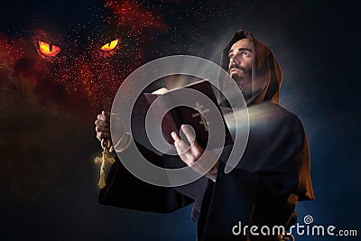 Medieval monk with spellbook calling the spirits Stock Photo