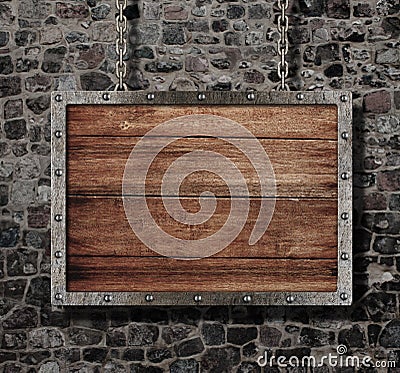 Medieval old sign with chain on stone wall Stock Photo