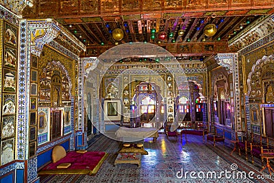 Royal City Palace Jaipur interior view of glass room with mirror and gold artwork at Rajasthan, India Editorial Stock Photo