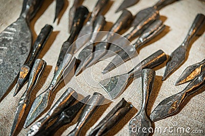 Medieval small arms. Steel arrowheads, horseshoes, spear. Stock Photo